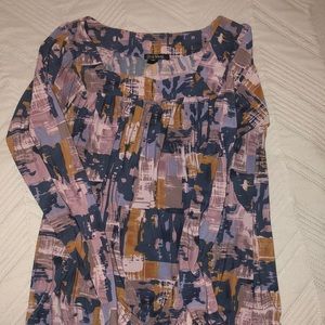 Dressy long sleeved blouse with gathered sleeves and bottom.